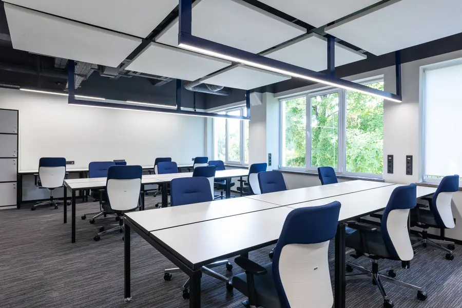 Bright modern office with desks and chairs ready for cleaning