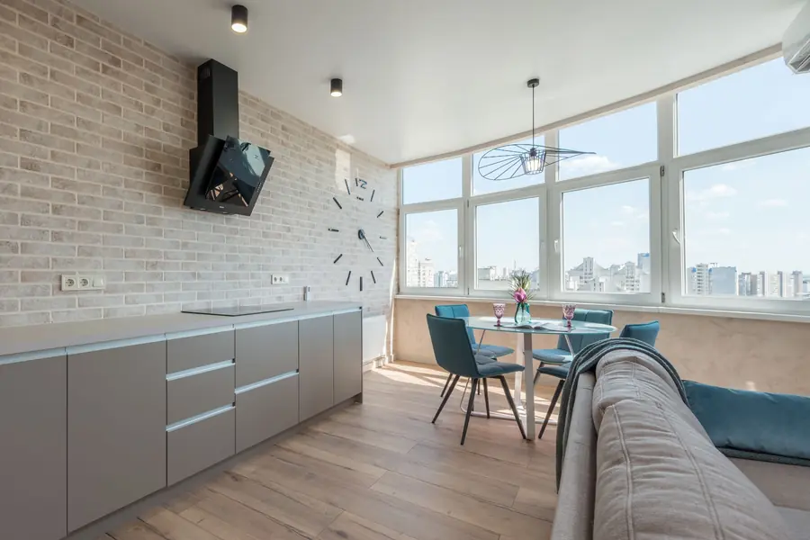 Bright, clean apartment living and dining area with a city view