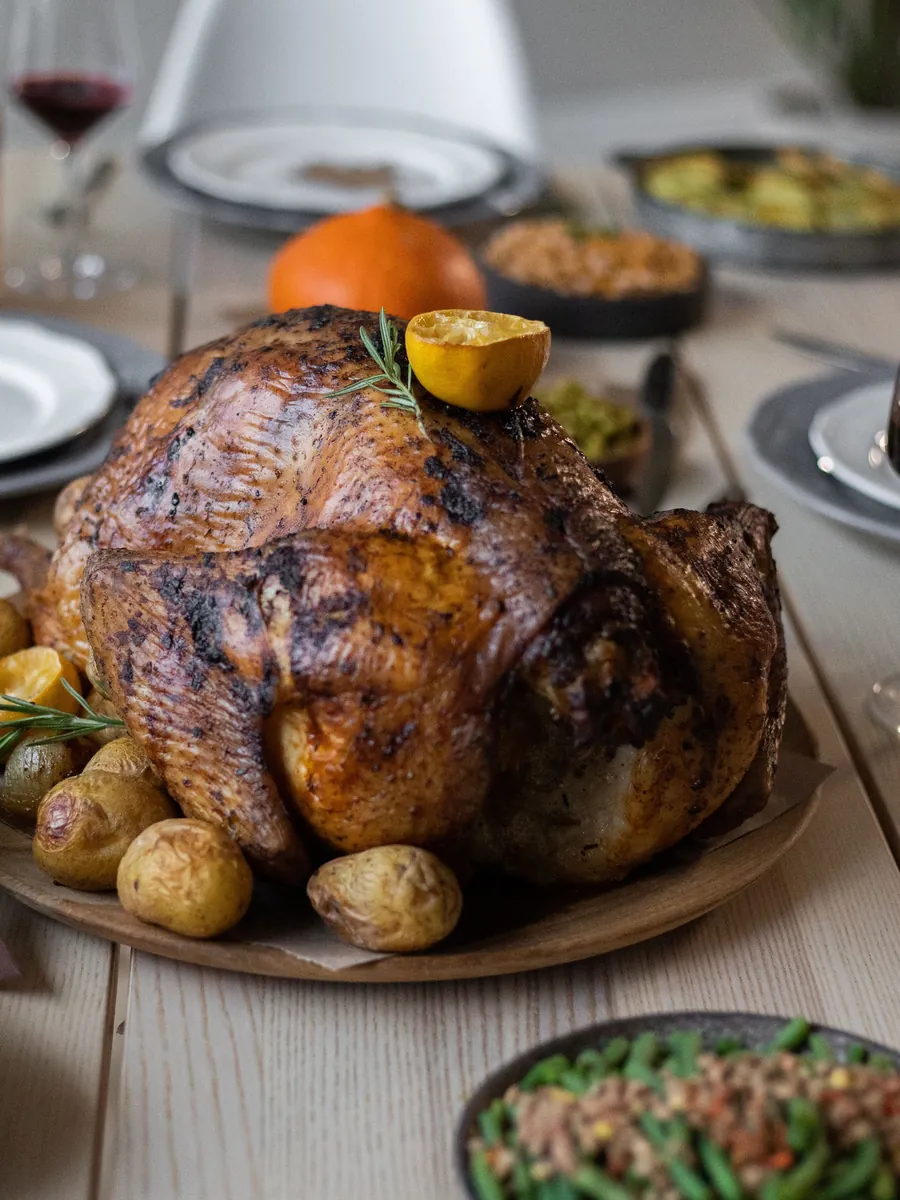 Roasted turkey on a set Thanksgiving dinner table